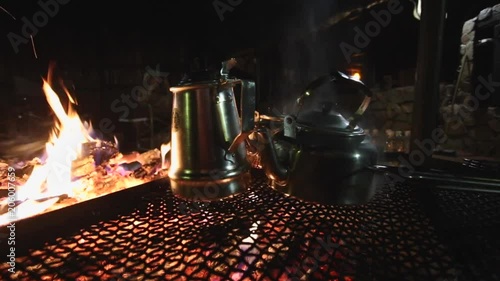 Metal Kettles Boil Over A Campfire photo