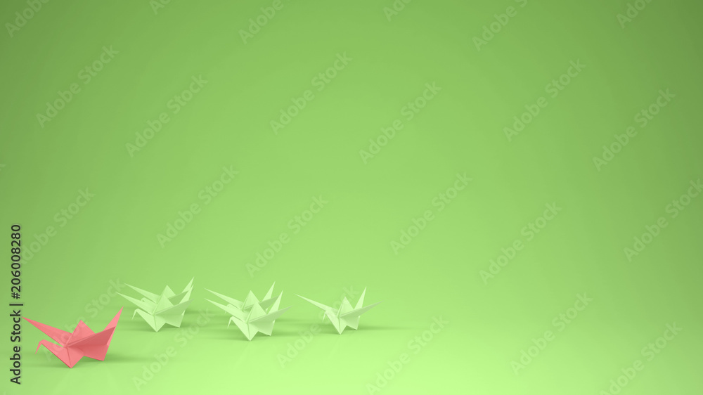 Origami pink paper crane leading group of cranes, leadership motivation concept idea with copy space, green background
