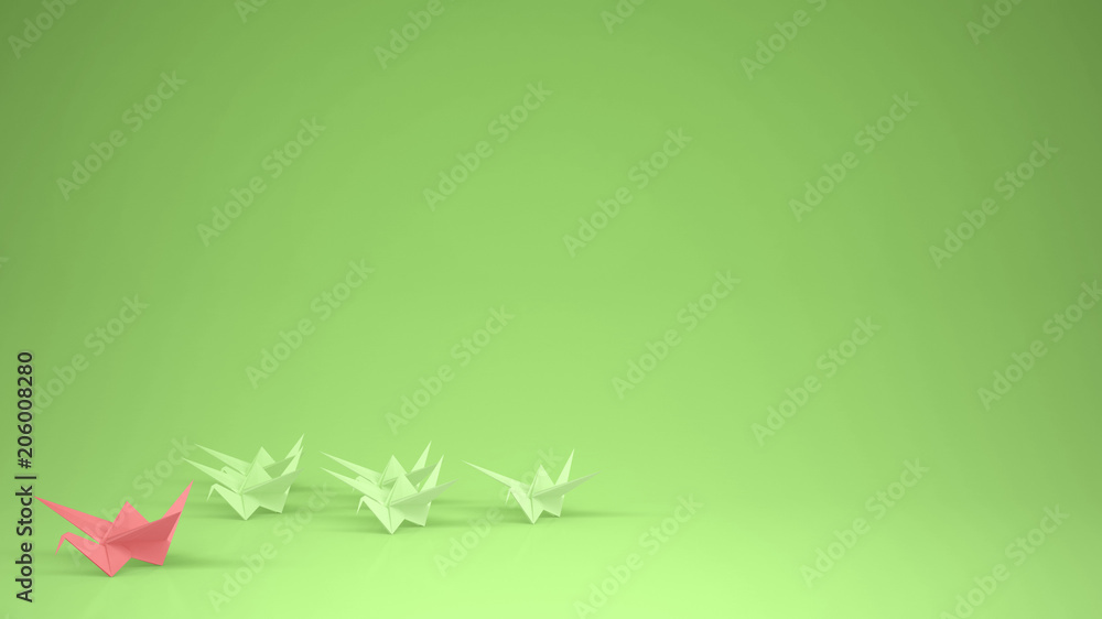 Origami pink paper crane leading group of cranes, leadership motivation concept idea with copy space, green background Origami pink paper crane leading group of cranes, leadership motivation concept idea with copy space, green background
