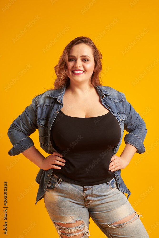 Beautiful plus-size model with big breast smiling at camera Stock Photo