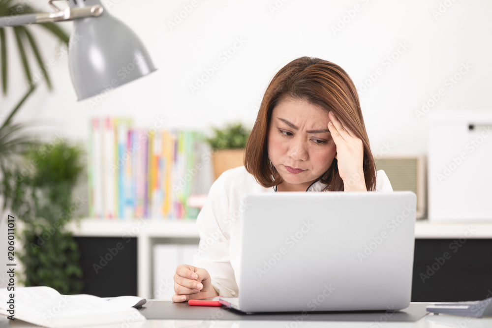 Asian woman using laptop at home office, Asian woman using laptop at home office,