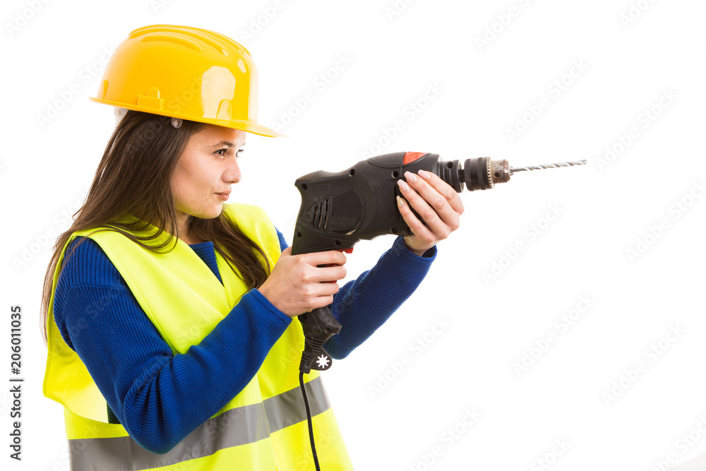 Young female engineer using drilling machine. Young female engineer using drilling machine.
