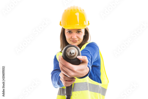 Young woman engineer using drilling machine.