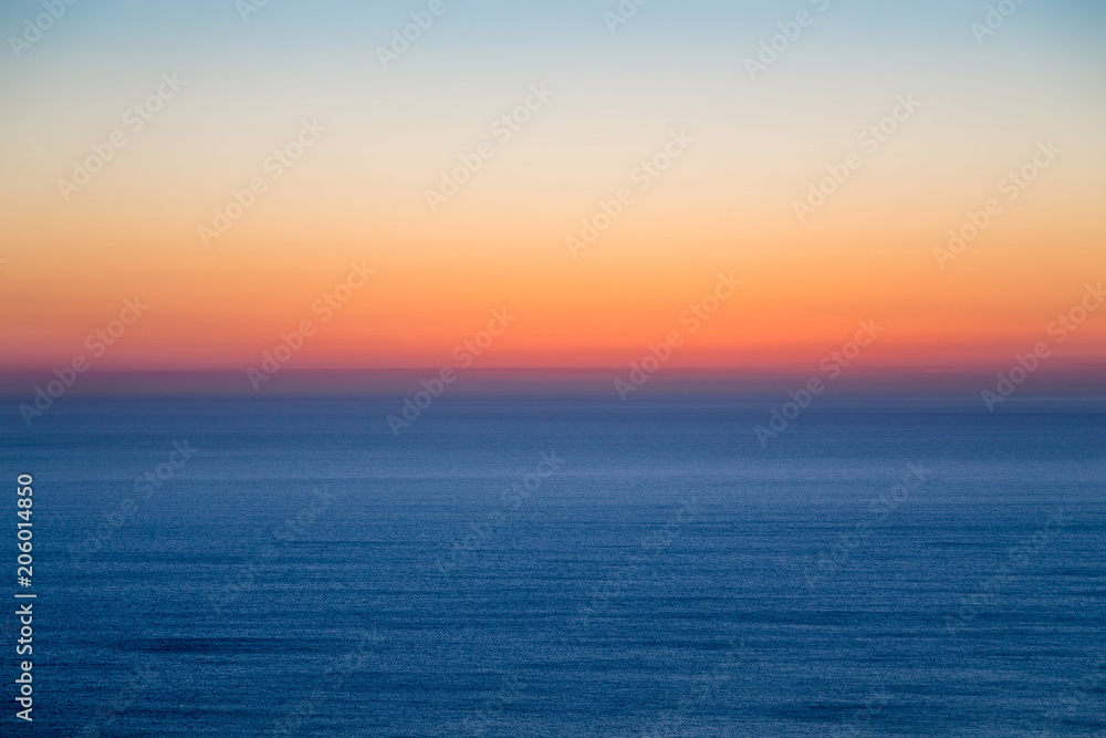 Seascape with colorful evening sky. Natural background. Beautiful sunset over the sea in the Atlantic ocean.