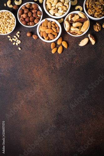 Nuts assortments on stone table top view.