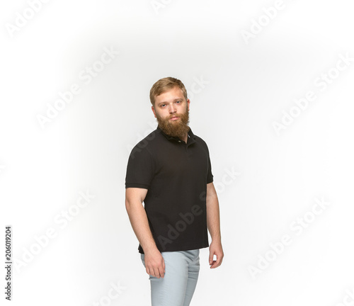 Closeup of young man's body in empty black t-shirt isolated on white background. Mock up for disign concept