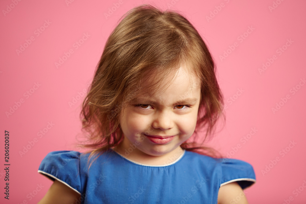 Close up portrait of upset little girl three years on pink isolated background, expresses frustration or resentment, demonstrates a negative character. Close up portrait of upset little girl three years on pink isolated background, expresses frustration or resentment, demonstrates a negative character.