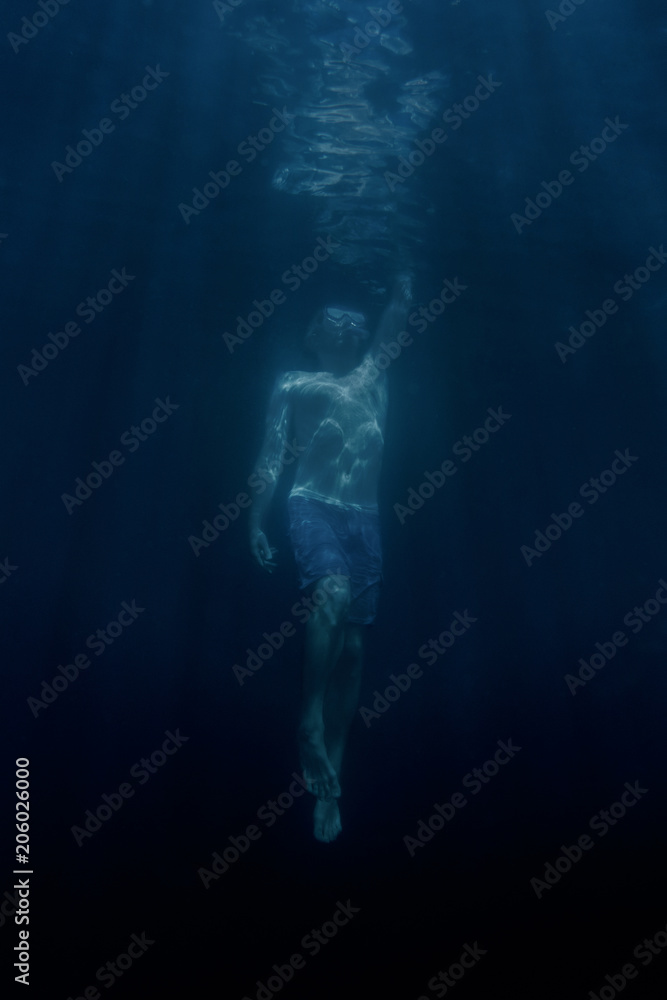 Man swimming up to the water surface. Man swimming up to the water surface.