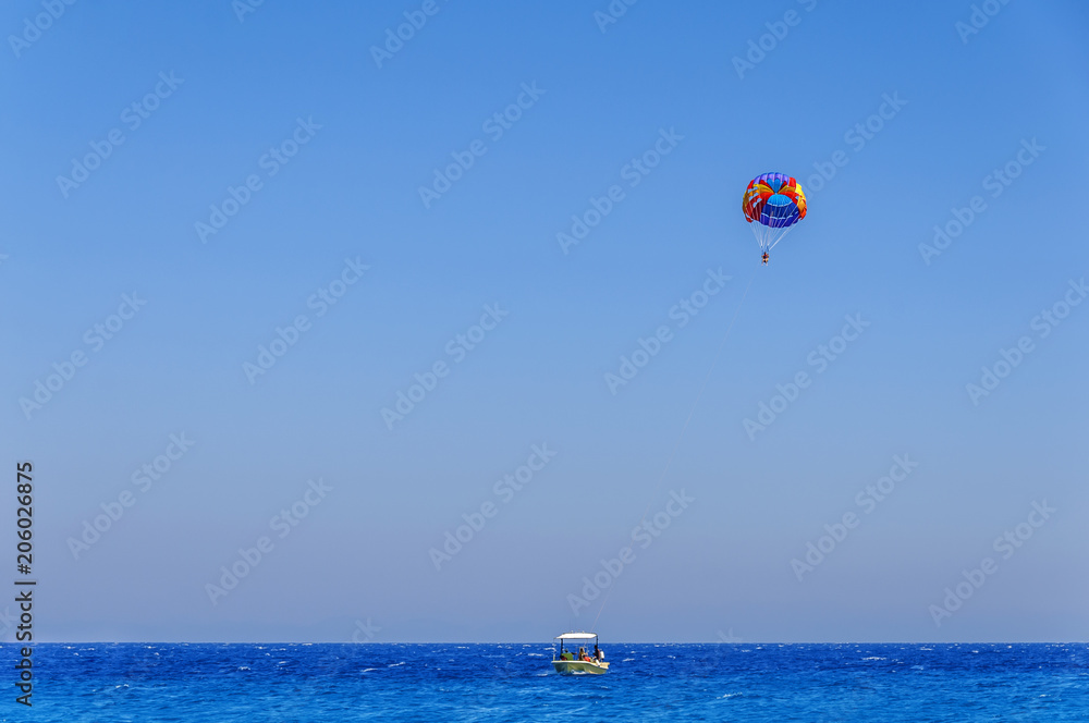 Parachute skiing on blue wave sea and big clean sky Parachute skiing on blue wave sea and big clean sky