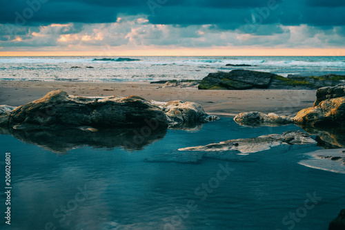 Beach with rocks and puddle in a sunset, ribadeo, spain