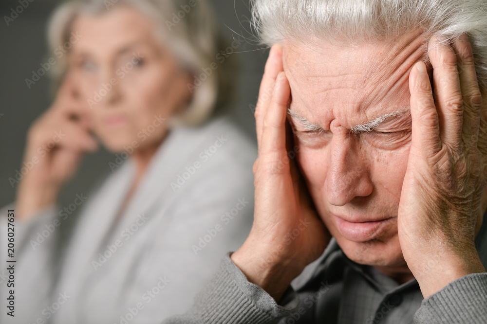 Fototapeta premium Senior man with headache holding