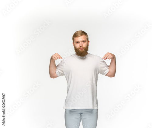 Closeup of young man's body in empty white t-shirt isolated on white background. Mock up for disign concept