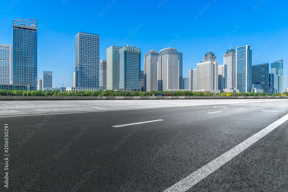 Empty urban road and modern skyline.