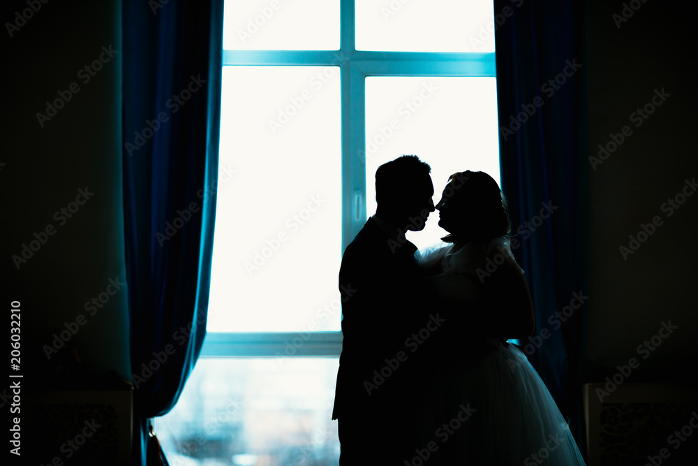 young bride and groom couple in a bright studio photo