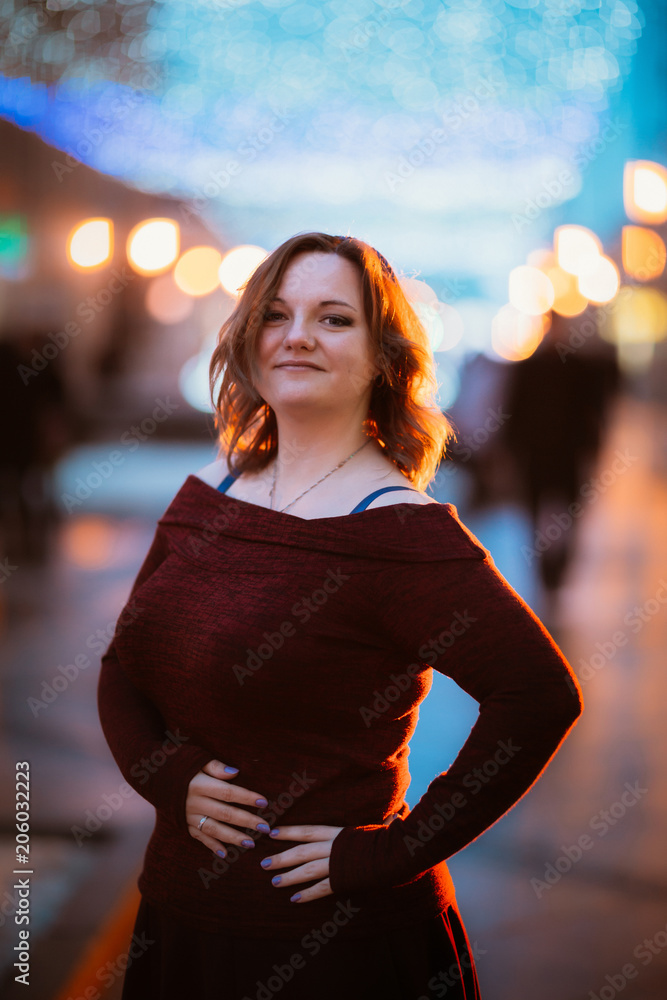 Fototapeta premium young woman posing on street background