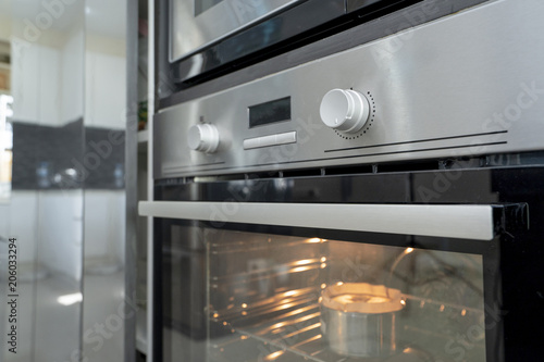 Microwave oven stainless steel in kitchen room modern home interior design cooking bread ready dinner food.