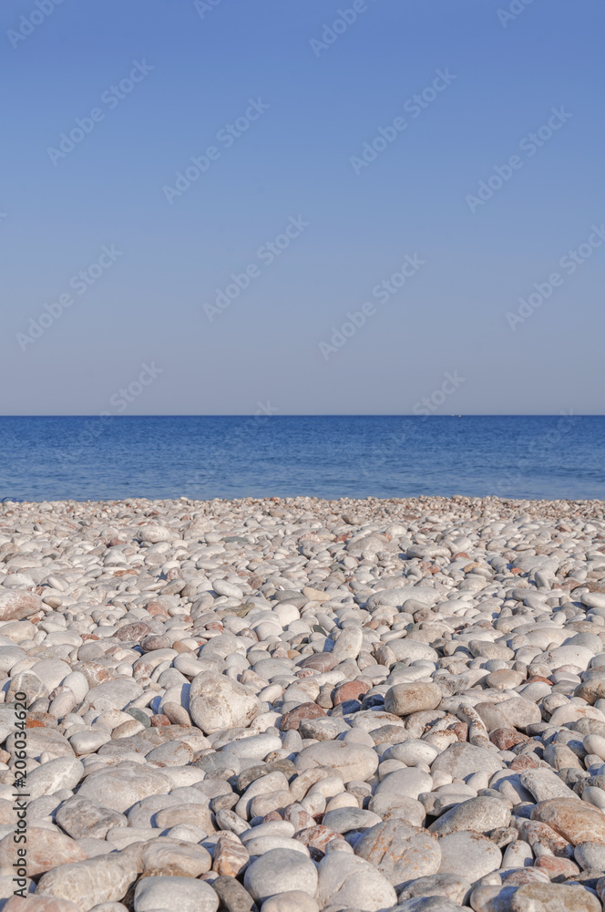 Pebble stony beach and blue wave sea with clean sky Pebble stony beach and blue wave sea with clean sky