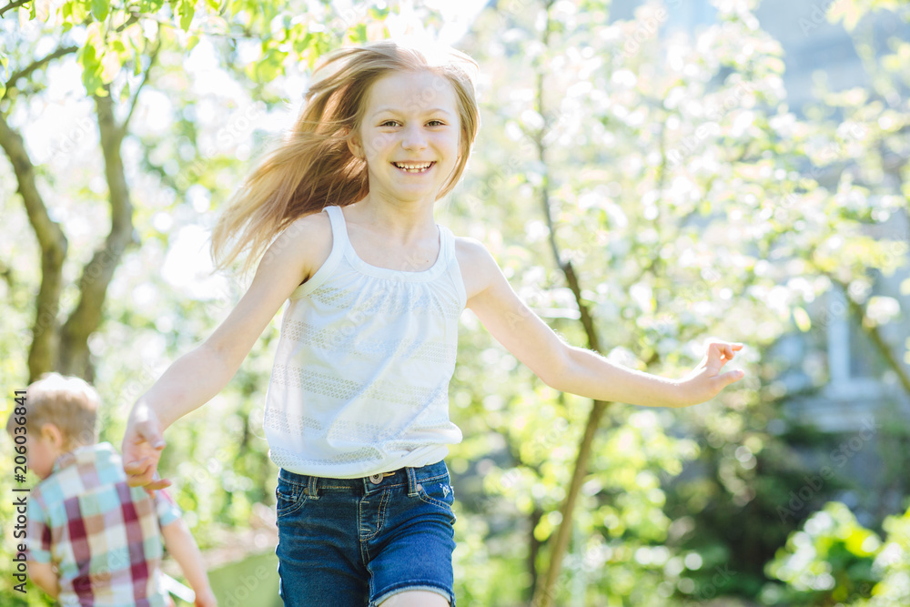 Adorable little girls running with open arms and a big smile on face. Summer vacation concept. Adorable little girls running with open arms and a big smile on face. Summer vacation concept.