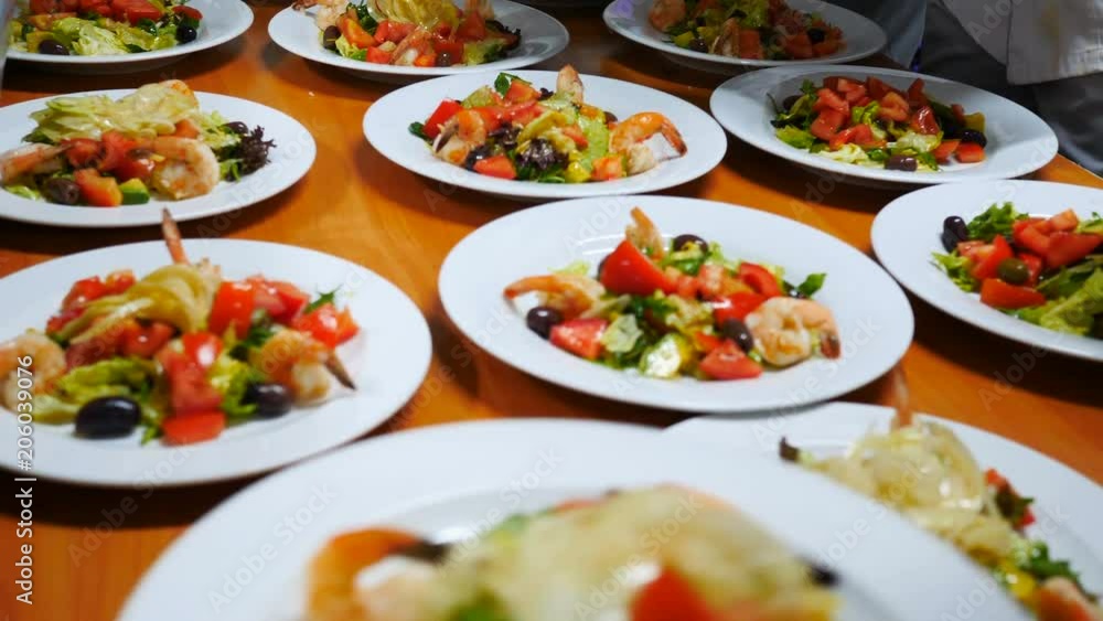 Fresh salad with avocado, cheese and tomatoes and olives and prawns are prepared Fresh salad with avocado, cheese and tomatoes and olives and prawns are prepared