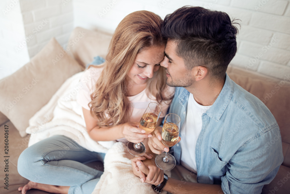 Young couple drink  wine in their living room