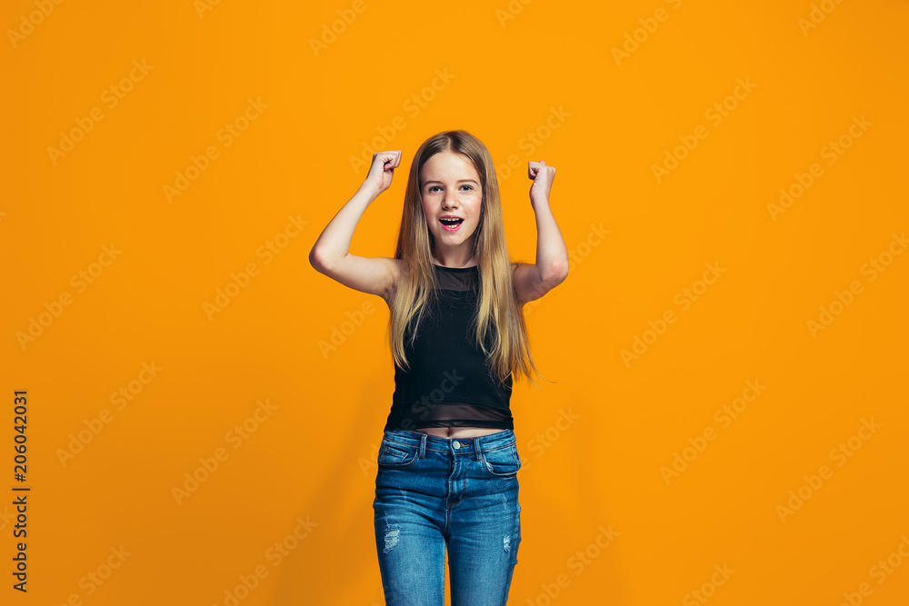 Happy success teen girl celebrating being a winner. Dynamic energetic image of female model Happy success teen girl celebrating being a winner. Dynamic energetic image of female model