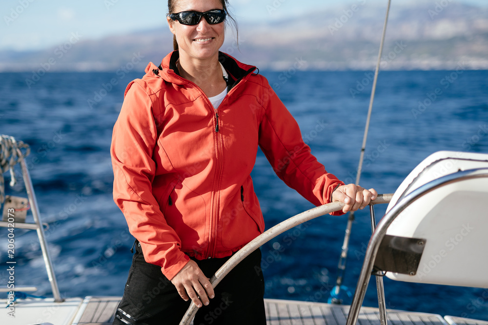 Attractive strong woman sailing with her boat Attractive strong woman sailing with her boat