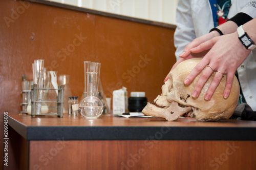 Hand with scull on lab background