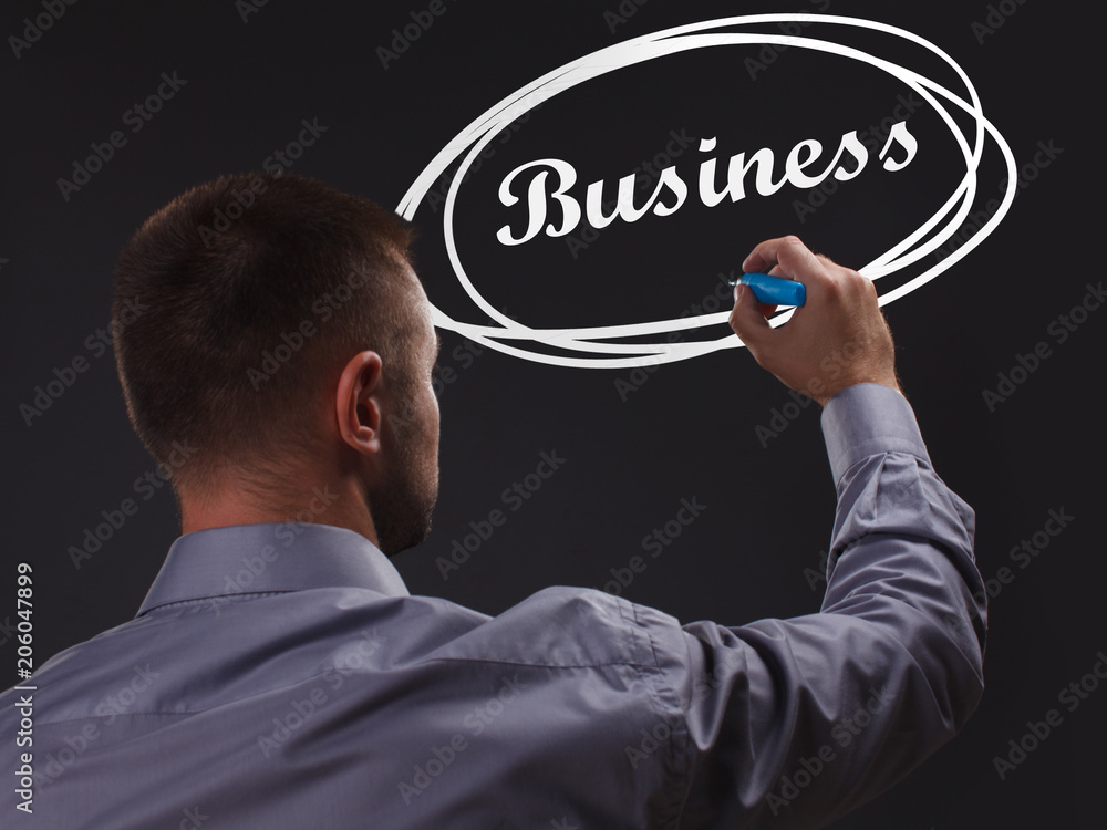 The concept of business, technology, the Internet and the network. Young businessman showing inscription: Business The concept of business, technology, the Internet and the network. Young businessman showing inscription: Business