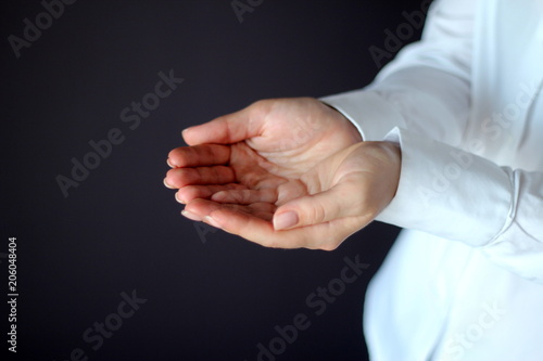 Young Woman's Hands Keeps Something Gesture