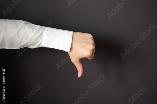 Young Woman's Hand Shows Thumbs Down Gesture