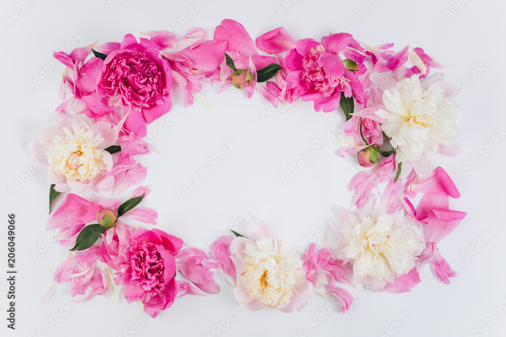 Floral frame wreath made of pink and white peonies flower buds. Flat lay, top view. Floral frame wreath made of pink and white peonies flower buds. Flat lay, top view.