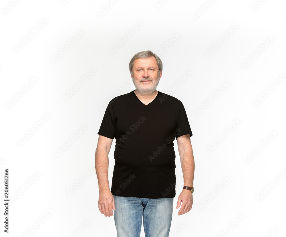 Closeup of senior man's body in empty black t-shirt isolated on white background. Mock up for disign concept Closeup of senior man's body in empty black t-shirt isolated on white background. Mock up for disign concept