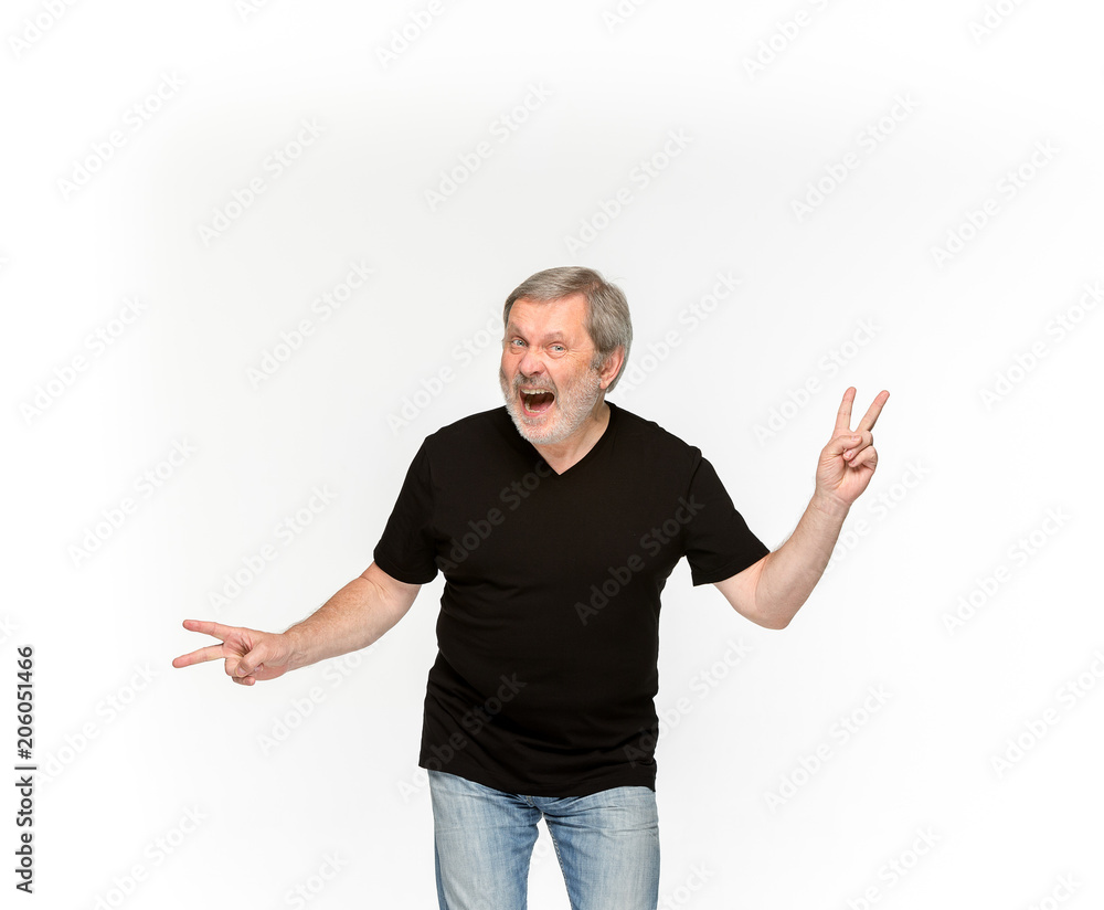 Closeup of senior man's body in empty black t-shirt isolated on white background. Mock up for disign concept Closeup of senior man's body in empty black t-shirt isolated on white background. Mock up for disign concept