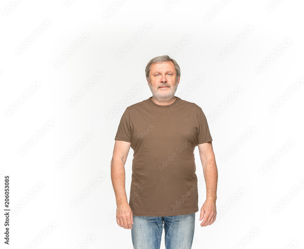 Closeup of senior man's body in empty brown t-shirt isolated on white background. Mock up for disign concept Closeup of senior man's body in empty brown t-shirt isolated on white background. Mock up for disign concept