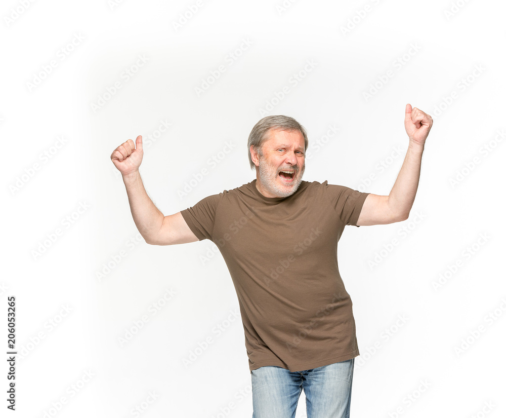Closeup of senior man's body in empty brown t-shirt isolated on white background. Mock up for disign concept Closeup of senior man's body in empty brown t-shirt isolated on white background. Mock up for disign concept