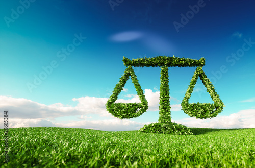 Eco friendly law, politics and eco balance concept. 3d rendering of scale icon on fresh spring meadow with blue sky in background. photo