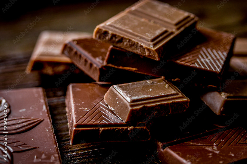 black chocolate close up on wooden background black chocolate close up on wooden background