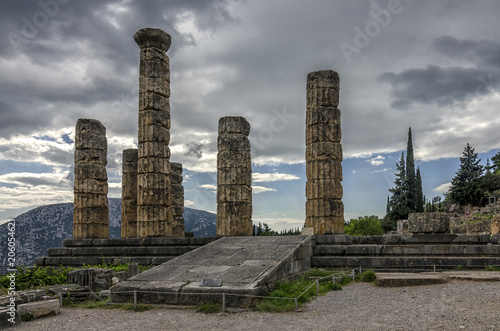 Delphi, Phocis - Greece. The famous Temple of Apollo at the archaeological site of Delphi. Dramatic cloudy sky