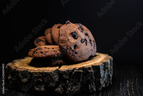 chocolate cookies with chocolate drops on wooden background
