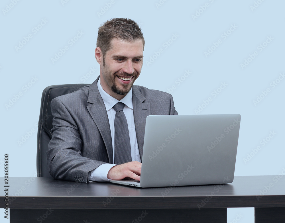 closeup.happy businessman working on laptop, sitting at desk closeup.happy businessman working on laptop, sitting at desk