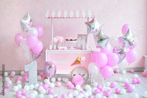 One year birthday decorations. Decorations for holiday party. a lot of balloons pink and white colors. Decorations for princes. 
