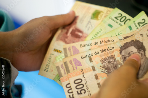 Hands counting Mexican money