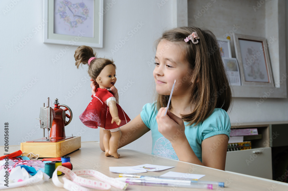 The girl is playing with a doll. The girl is playing with a doll.