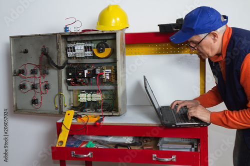 electrician fixing electrical system with different tools