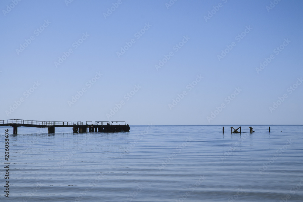 Blue sea. Blue sky. Some architectural objects in the water. Calm and minimalism composition Blue sea. Blue sky. Some architectural objects in the water. Calm and minimalism composition