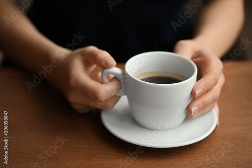 Woman with cup of aromatic coffee  closeup