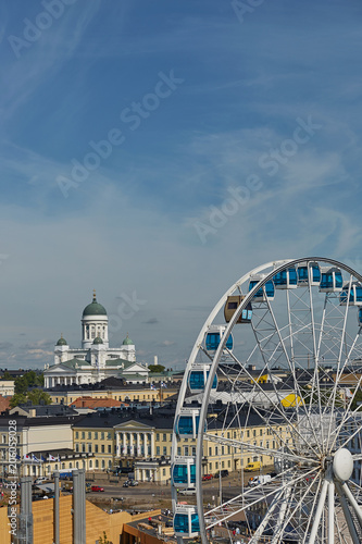 Ferris wheel and Cathedral of the Diocese of Helsinki  finnish Evangelical Lutheran church  located in the neighborhood of Kruununhaka in Helsinki  Finland
