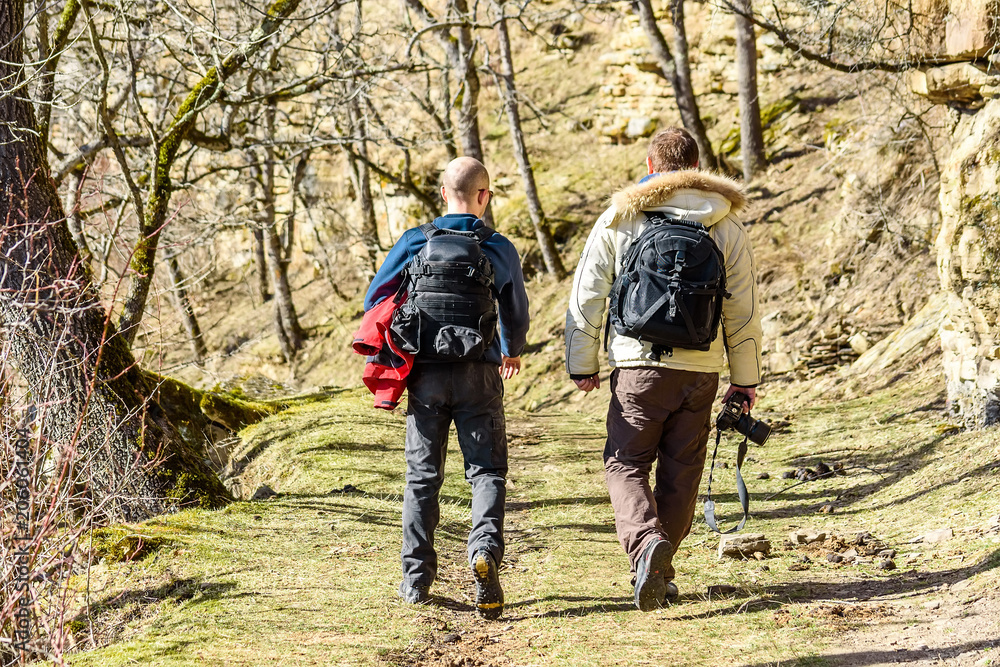 Two outdoor photographers in autumn forest