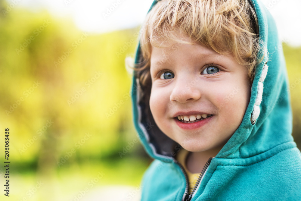 A happy toddler boy outside in spring nature. Close up. A happy toddler boy outside in spring nature. Close up.