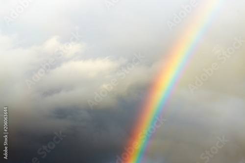 a bright rainbow on a dark stormy sky. © makam1969